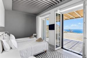 a bedroom with a bed and a view of the ocean at Pasithea Horizon in Kampos Paros +37 photos