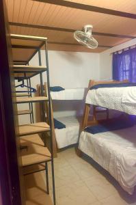 a dorm room with three bunk beds and a ladder at Casa Stay Villa de Guaduas in Guaduas +2 photos