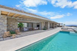 a villa with a swimming pool and a patio at Pasithea Horizon in Kampos Paros