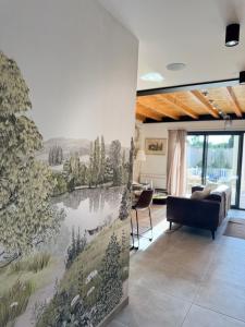 a living room with a mural on the wall at Maison des Passeroses in Boutiers-Saint-Trojan