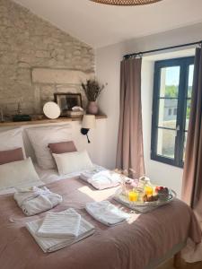 a bed with a tray of food on top of it at Maison des Passeroses in Boutiers-Saint-Trojan