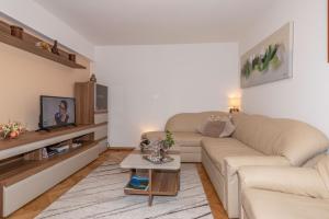 a living room with a couch and a table at Villa Teodora, an ideal holiday hideaway for families and friends in Krapan