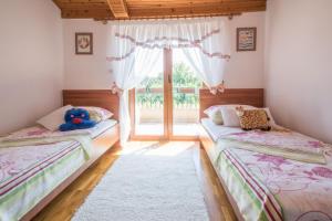 two beds in a room with a window at Villa Teodora, an ideal holiday hideaway for families and friends in Krapan +22 photos