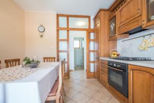 a kitchen with a table and a stove top oven at Villa Teodora, an ideal holiday hideaway for families and friends in Krapan