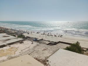 a group of people on a beach with the ocean at لؤلؤة البحر in Alexandria +4 photos