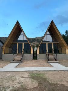 two peaked roofs of a building with stairs at Eldos_Kolsai in Saty