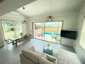 a living room with a couch and a tv and a table at Villa Maria in Elani