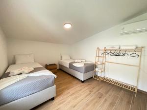 a room with two beds and a ladder at Villa Maria in Elani +48 photos