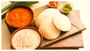 a cutting board with bread and a bowl of soup and dip at LUCKNOW HOTEL METRO REGENCY - Near Railway Station And Temple -#Free Wi-Fi #Restrurant #Parking Facilities # Fully Air-Condition- A Premium Hotel In Lucknow in Lucknow +15 photos