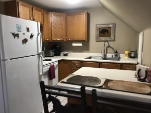 a kitchen with a white refrigerator and a table at Cozy Mother-in-Law Apartment in Osceola