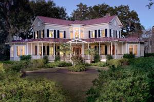 a white house with a red roof at 5 Bedroom Wilson Village Home 33 in Bluffton