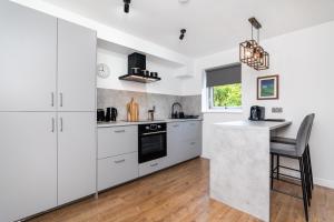 a kitchen with white cabinets and a counter top at 2Bedroom Apartment-Free Parking in Edinburgh