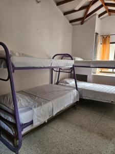 En eller flere senge i et værelse på Cómoda casa cerca a la playa