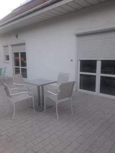 a patio with a table and chairs on a patio at Pokoje gościnne Ania in Mikoszewo