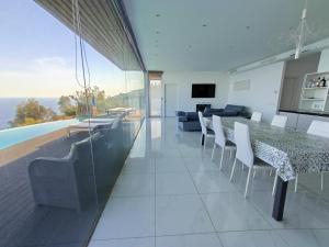 a dining room and living room with a table and chairs at Villa Luxury Paradise in Salobreña
