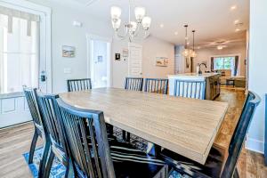 a dining room and kitchen with a wooden table and chairs at 4563 Summey in Charleston