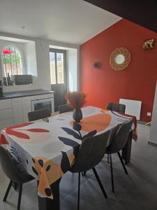 ein Esszimmer mit Tisch und Stühlen in der Unterkunft Charmante maison familiale in Saint-Fort