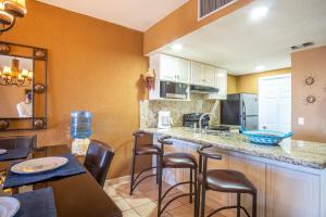 a kitchen with a counter and some chairs in a room at Princesa De Penasco in Punta Penasco New +18 photos