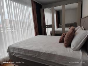 a bedroom with a large bed with a large mirror at Luxury Apartment Sarajevo Free parking in Sarajevo