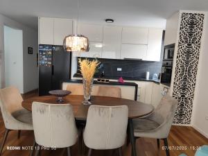 a kitchen with a dining room table and chairs at Luxury Apartment Sarajevo Free parking in Sarajevo