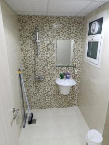 a bathroom with a sink and a mirror at Zaza home in Ajman  +25 photos