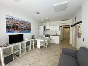 a living room with a kitchen and a dining room at PinHouse in Cagliari