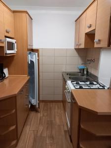 a kitchen with a sink and a stove top oven at Középső szint in Zamárdi