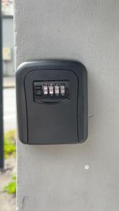 a black electrical outlet on the side of a wall at Arendal Sentrum Ro in Arendal