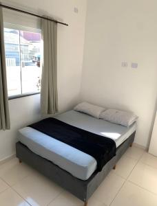 Postel nebo postele na pokoji v ubytování Casa no Litoral em Matinhos
