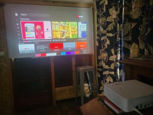 a large screen tv with a video game on it at Loft Apartment at Moulin SAGE in Treignac
