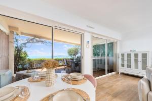 a living room with a table and a large window at Le Chevalier in Cap d'Ail