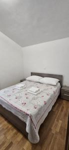 a bedroom with a bed with a blanket on it at Apartman Mare in Zadar +9 photos