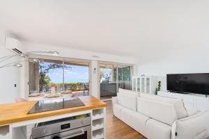 a living room with a couch and a tv at Le Chevalier in Cap d'Ail