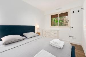 a bedroom with a bed with a blue headboard and a window at Le Chevalier in Cap d'Ail +30 photos