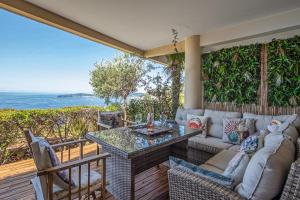 a patio with a couch and a table and chairs at Le Chevalier in Cap d'Ail