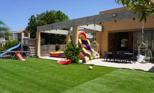 a backyard with a playground with a slide at House in the farm מקום שומר שבת וכשרות in HaZore‘im