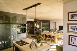 a kitchen and living room with a dining room at Maison De Plage in Umdloti