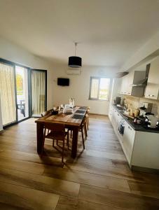 a kitchen with a wooden table and a wooden floor at B&B Mastro Mario in Rocca di Neto +8 photos