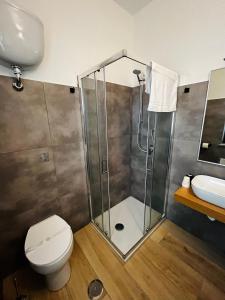 a bathroom with a shower and a toilet and a sink at B&B Mastro Mario in Rocca di Neto