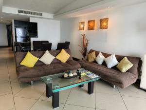 a living room with two couches and a coffee table at Oceanfront Condo in Ixtapa, Zihuatanejo in Ixtapa