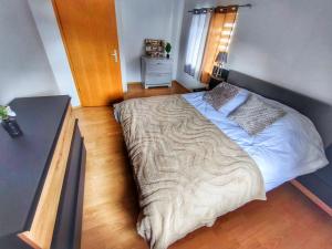 a bedroom with a large bed with a wooden floor at Le grain noble de Wissembourg in Wissembourg