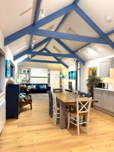 a kitchen and living room with a table and chairs at Ocean Heart Studio- Luxury, Rural Retreat in Wendron