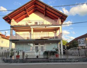 a house with a balcony on top of it at Prenoćište BORIK in Sanski most
