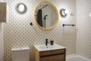 a bathroom with a sink and a mirror on the wall at Casa Azul - 2min walk to the Beach, in the Historical Center of Sesimbra in Sesimbra +34 photos