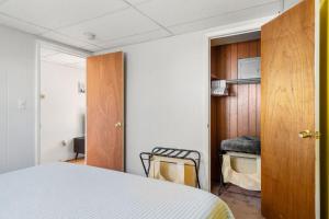 a bedroom with a bed and a desk with a chair at Nothing Fancy Older Apt Walk to Downtown King Bed in Dover
