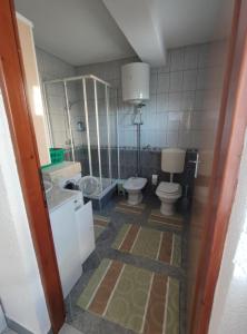 a bathroom with two toilets and a sink at Prenoćiste Borik in Sanski most +3 photos