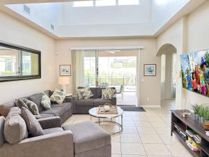 a living room with a couch and a table at 5 bedrooms pool home Calabay in Davenport