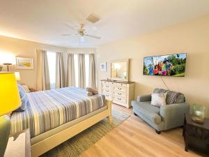 a bedroom with a bed and a chair and a dresser at 5 bedrooms pool home Calabay in Davenport +24 photos