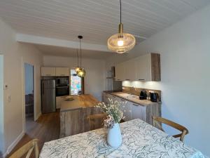 a kitchen with a table with a vase on it at Villa EtcheOna in Soorts-Hossegor