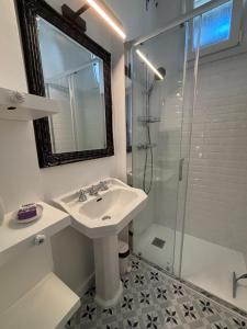 a white bathroom with a sink and a shower at Villa EtcheOna in Soorts-Hossegor +6 photos